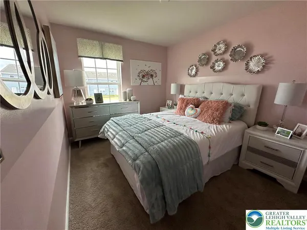 a bed room with a bed and a painting on the wall
