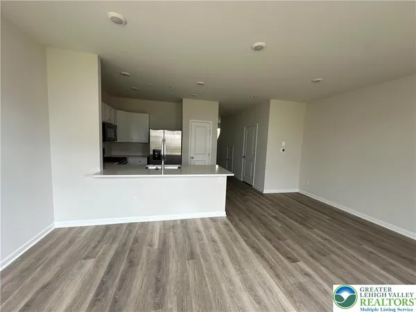 a view of kitchen with microwave and wooden floor