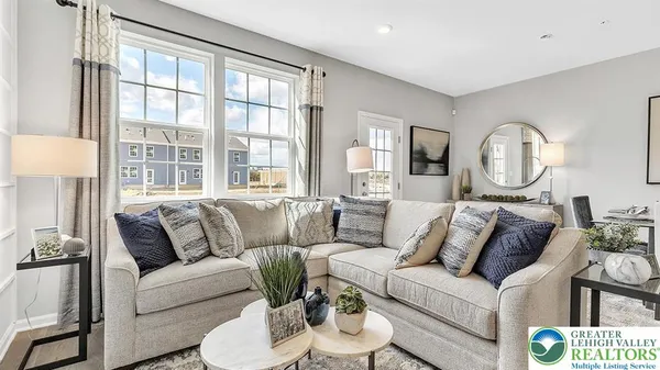 a living room with furniture and a large window