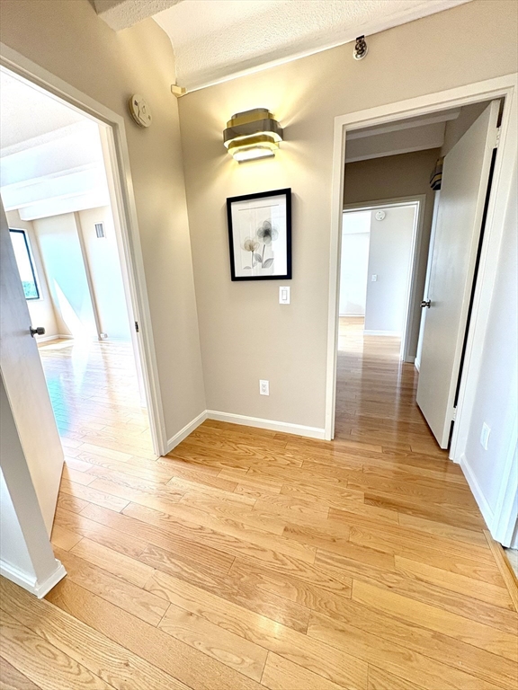 1731 Beacon Street, Unit 1502 Brookline, MA 02445 - Photo 14 of 27 a view of a hallway with wooden floor and a bathroom