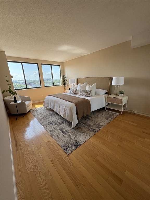 1731 Beacon Street, Unit 1502 Brookline, MA 02445 - Photo 18 of 27 a spacious bedroom with a bed and window