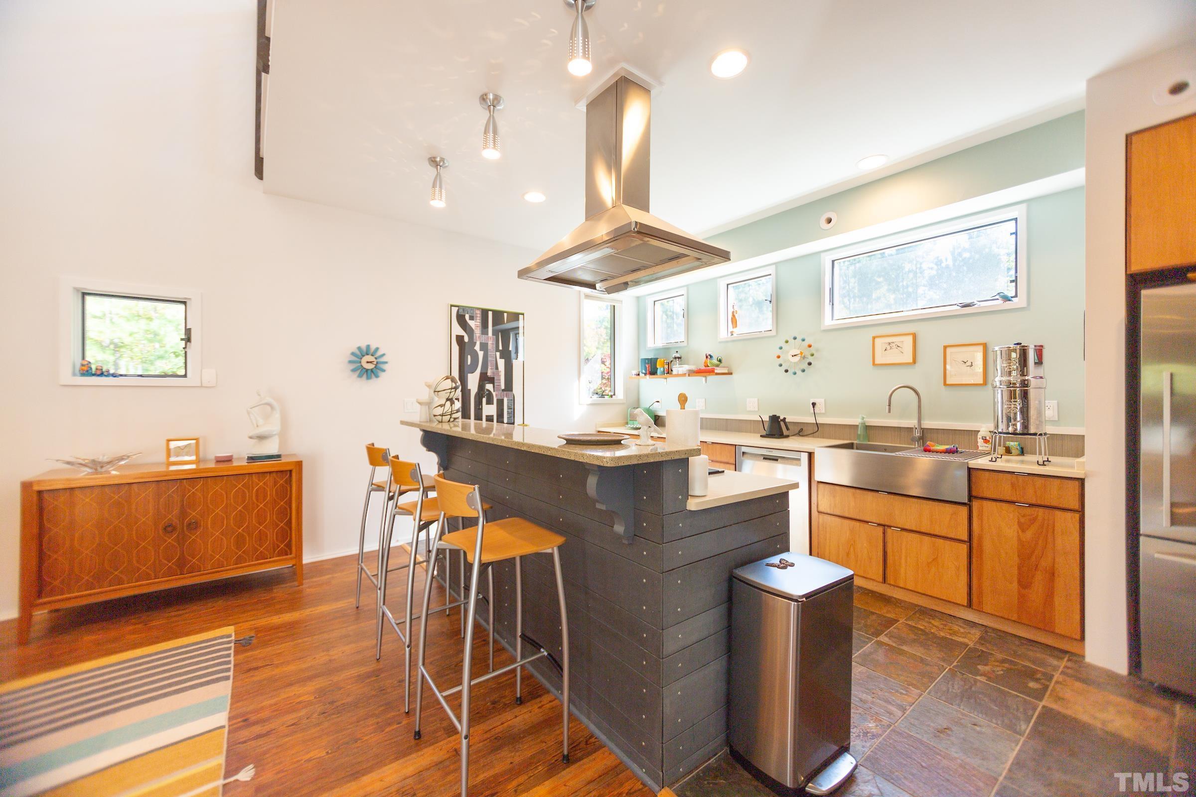 116 Solterra Way Durham, NC 27705 - Photo 9 of 30 a kitchen with stainless steel appliances granite countertop a sink stove and wooden floor