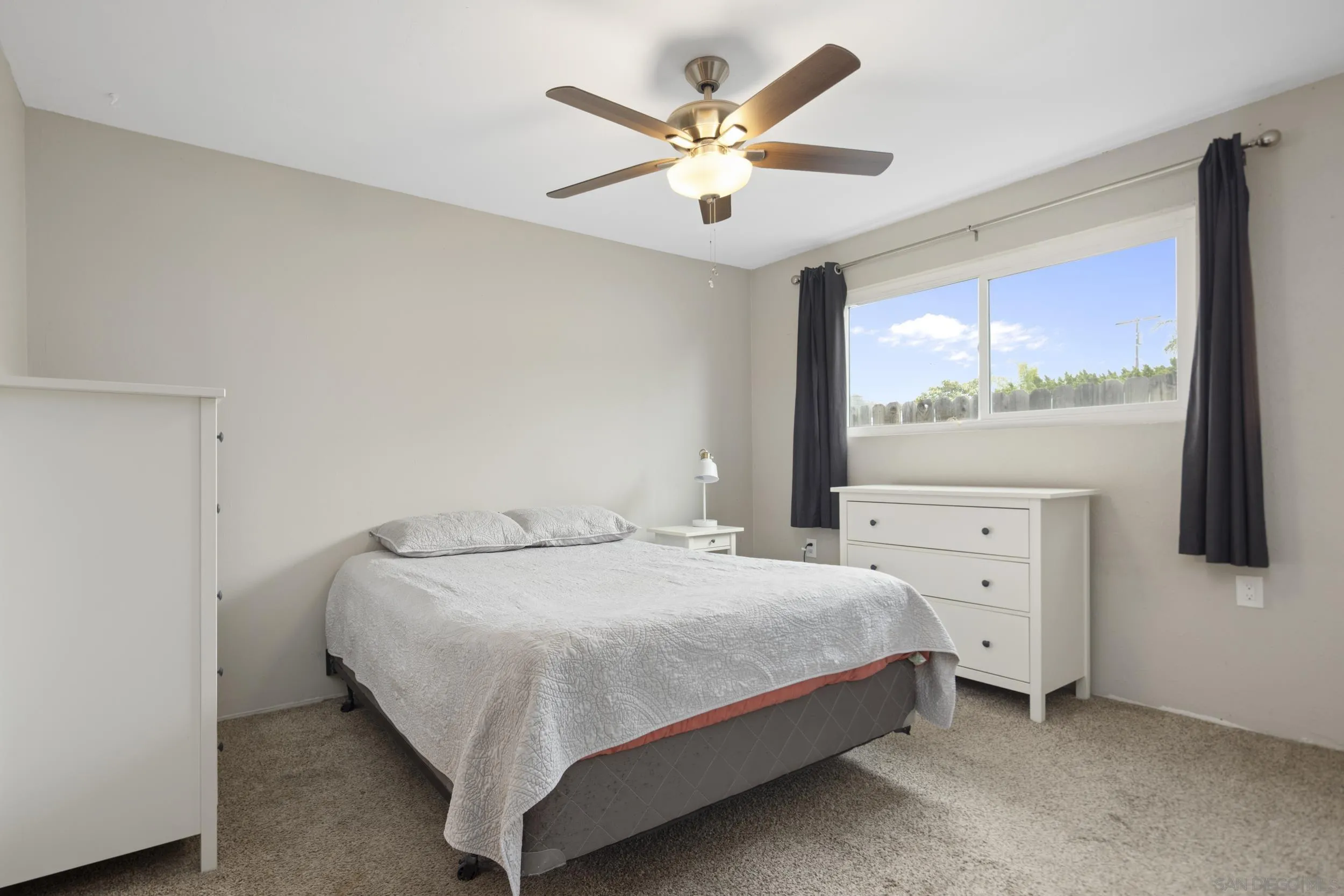 622 Ellen Lane El Cajon, CA 92019 - Photo 12 of 17 a bedroom with a large bed and a chandelier