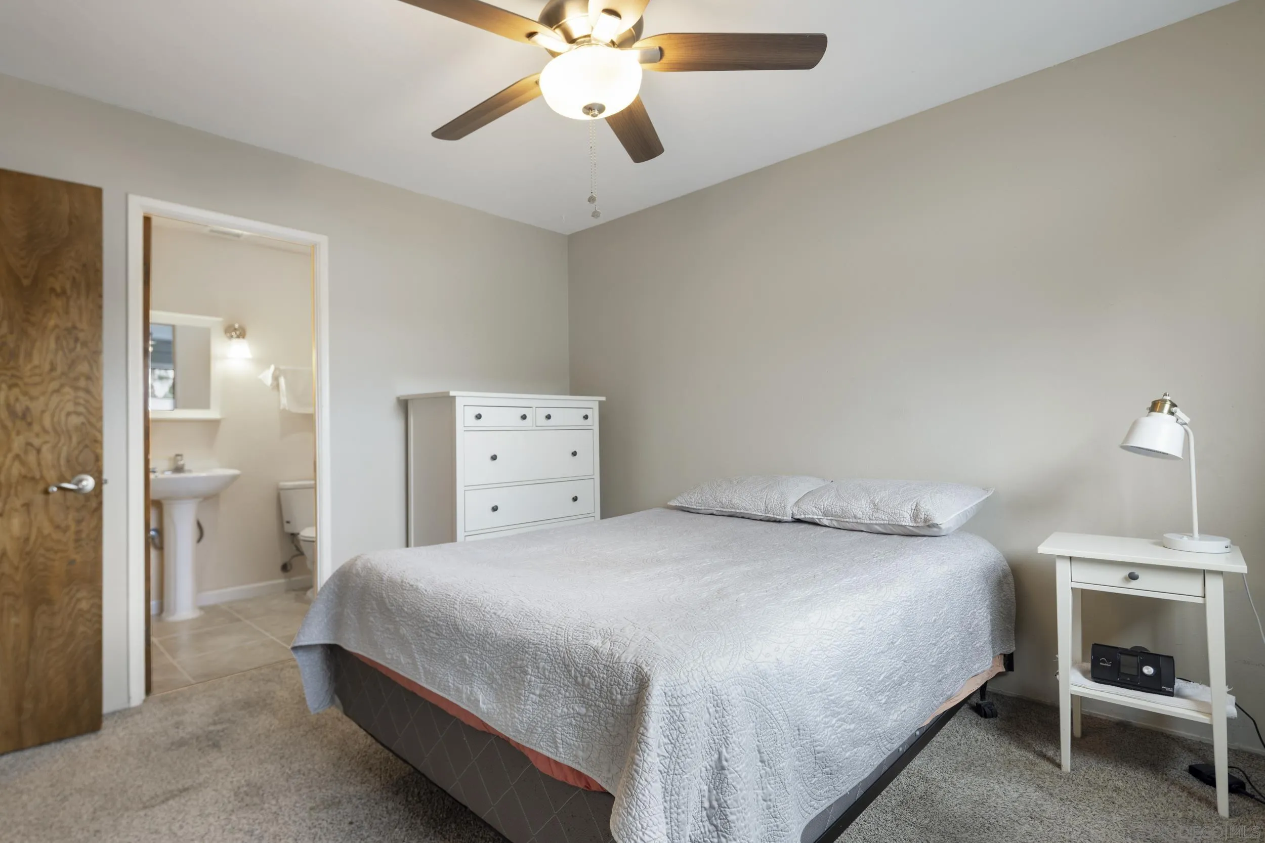 622 Ellen Lane El Cajon, CA 92019 - Photo 13 of 17 a bedroom with a bed and a chandelier