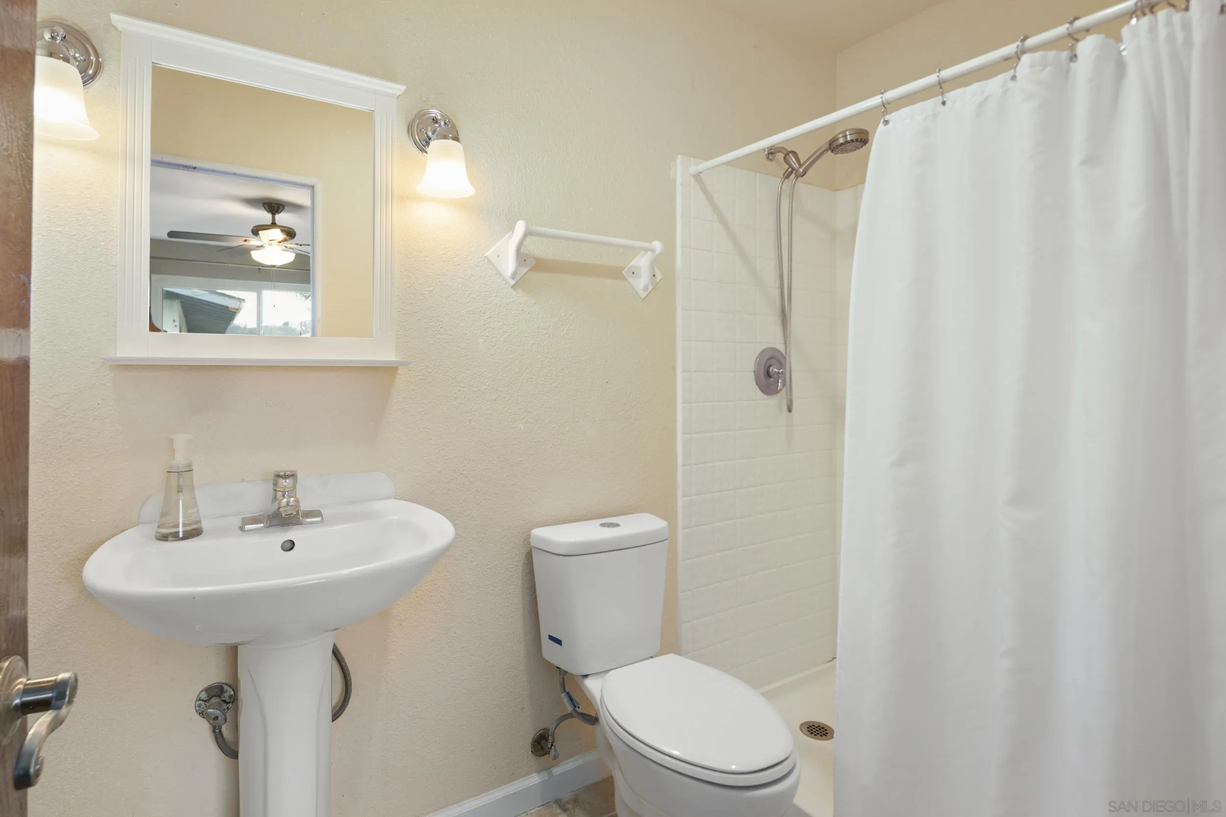 622 Ellen Lane El Cajon, CA 92019 - Photo 14 of 17 a bathroom with a sink a mirror a toilet and shower