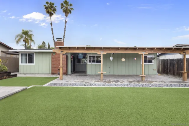a front view of a house with a garden and yard