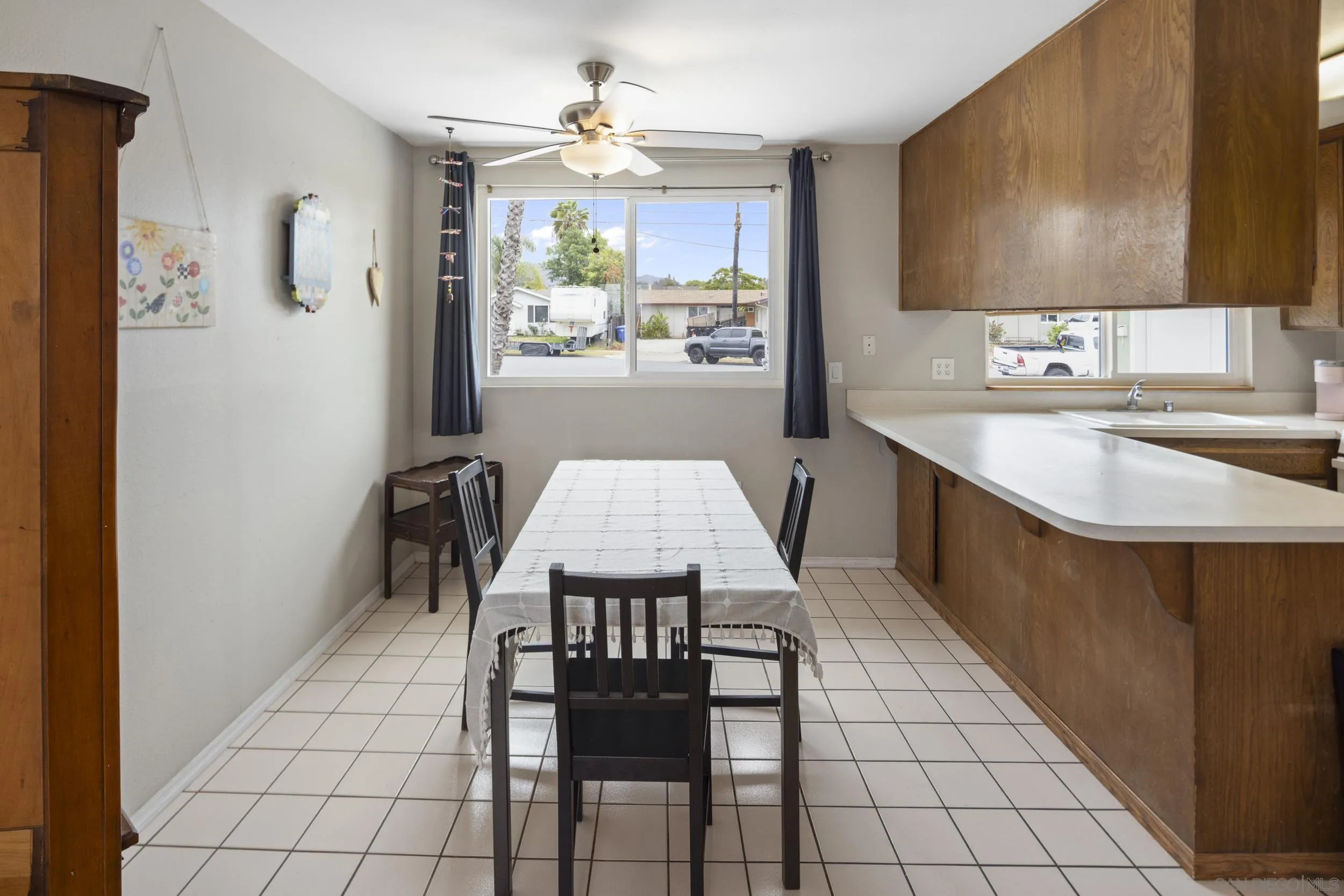622 Ellen Lane El Cajon, CA 92019 - Photo 9 of 17 a kitchen with stainless steel appliances a table chairs and a refrigerator