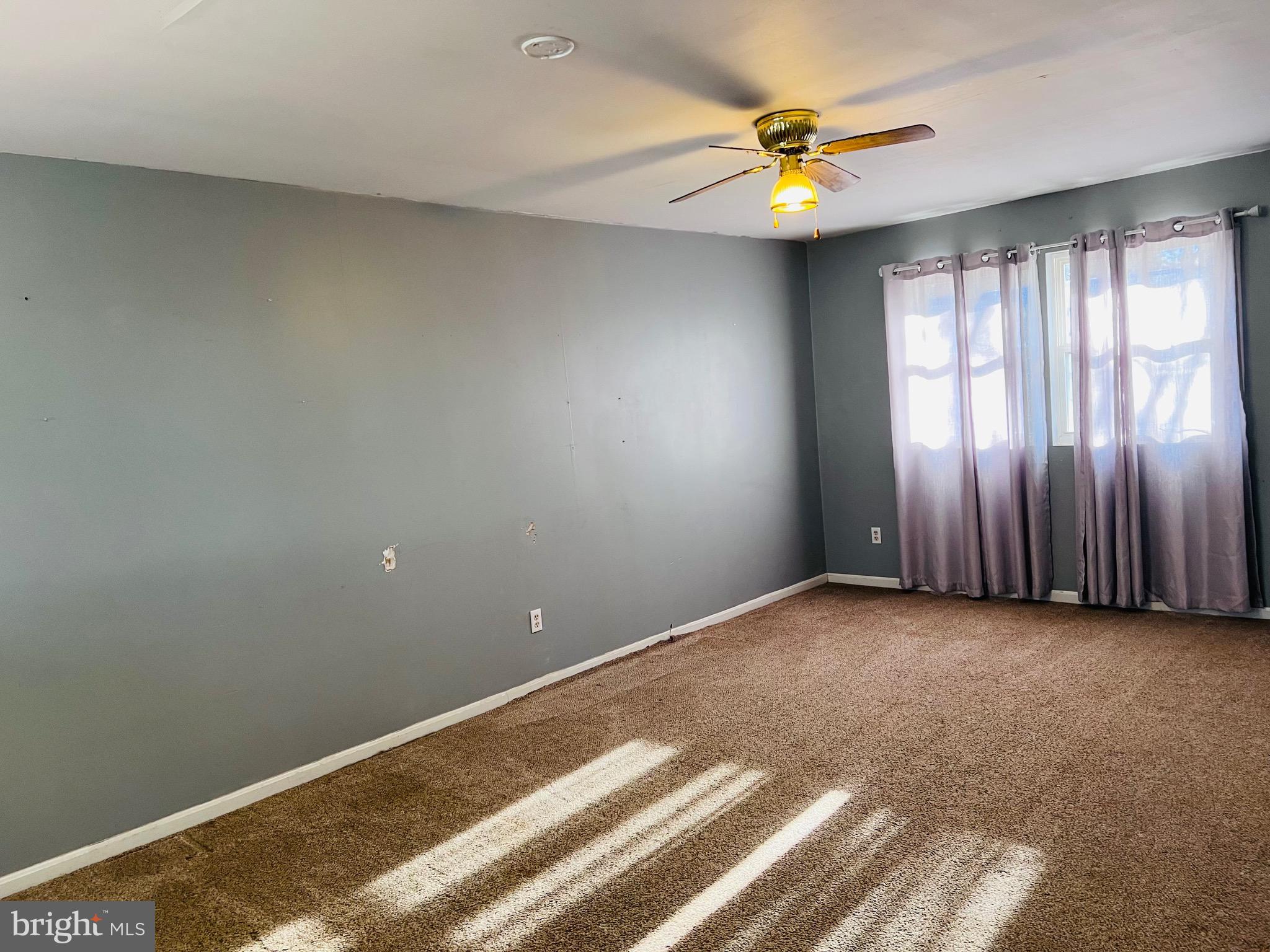 320 Cedar Avenue Colonial Beach, VA 22443 - Photo 22 of 47 an empty room with a window and a ceiling fan