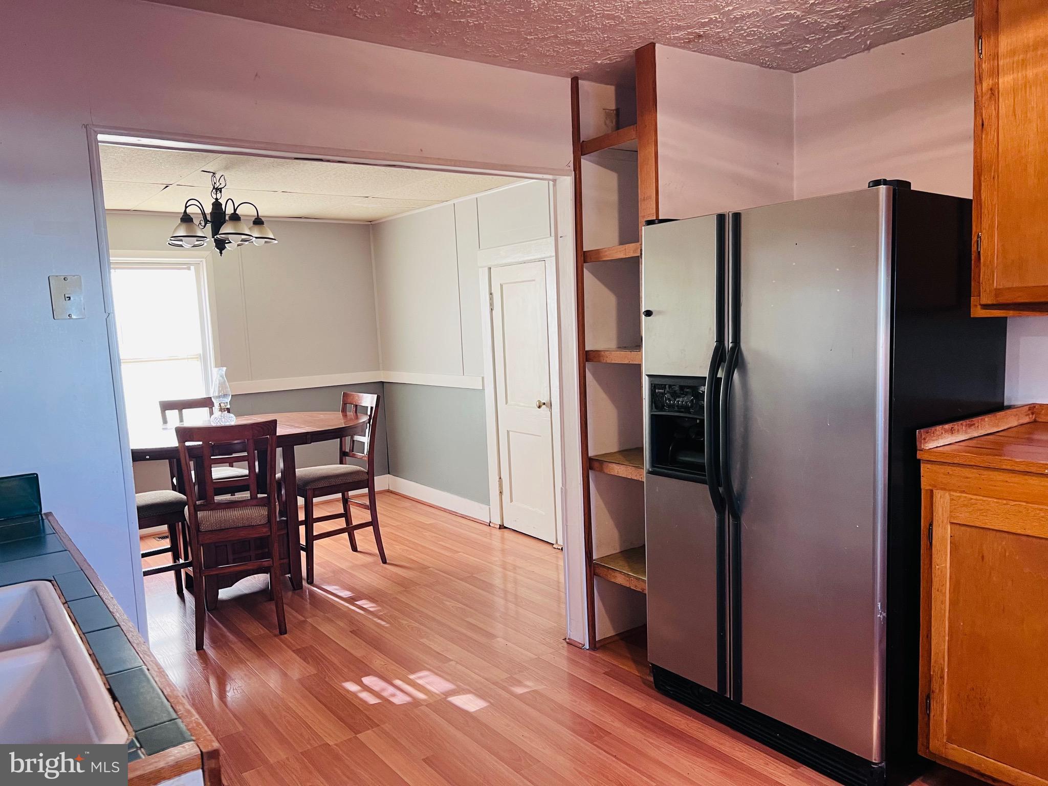 320 Cedar Avenue Colonial Beach, VA 22443 - Photo 23 of 47 a kitchen with stainless steel appliances a refrigerator a table and chairs