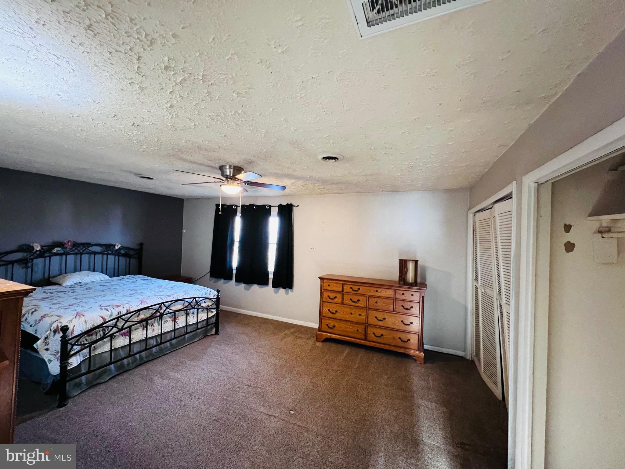 320 Cedar Avenue Colonial Beach, VA 22443 - Photo 31 of 47 a spacious bedroom with a bed and a night stand