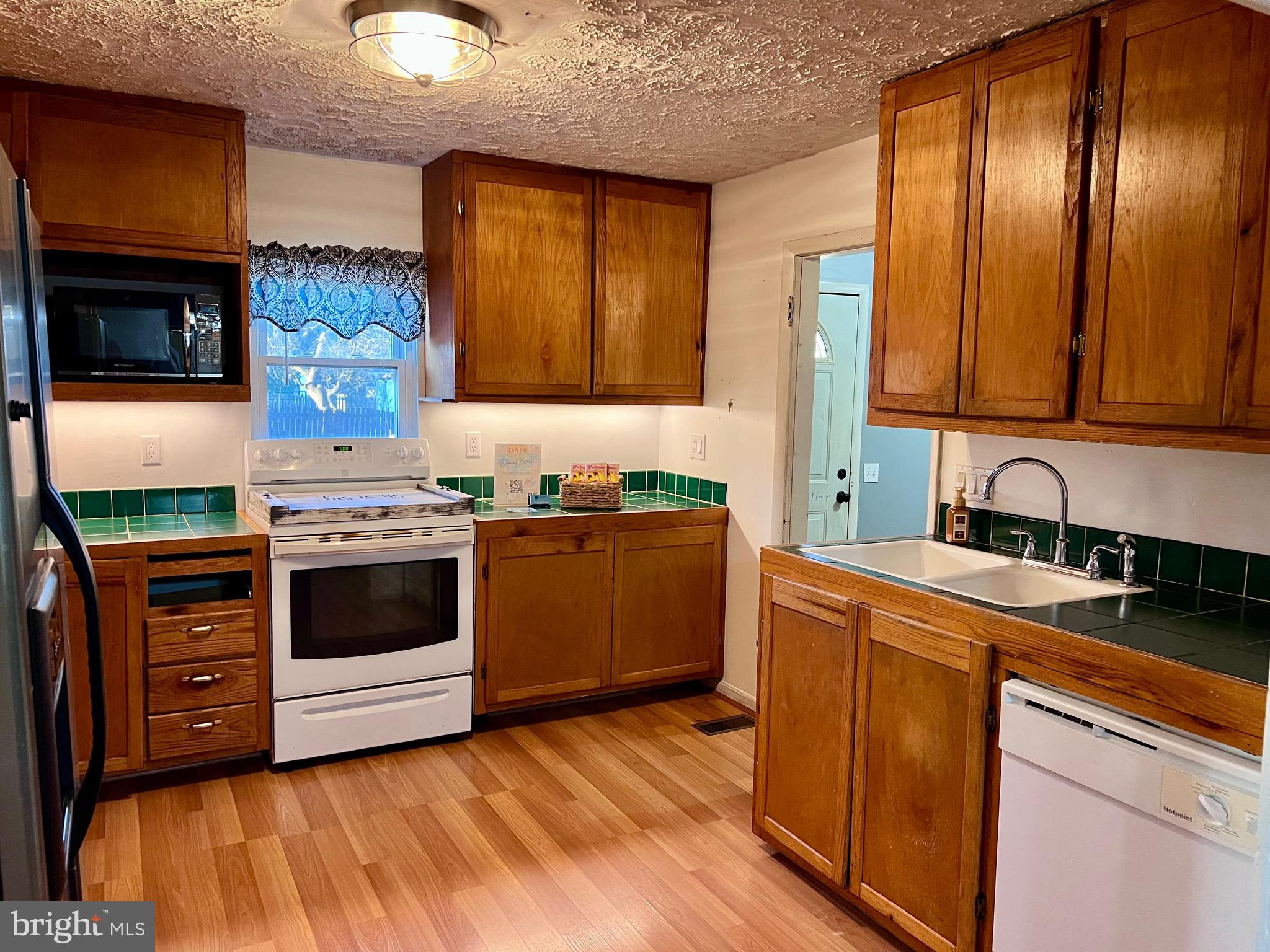 320 Cedar Avenue Colonial Beach, VA 22443 - Photo 39 of 47 a kitchen with stainless steel appliances granite countertop a stove a sink and a refrigerator