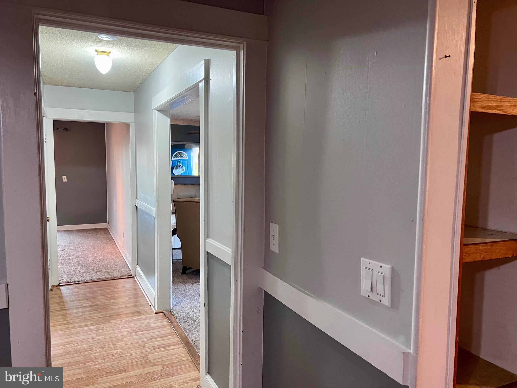 320 Cedar Avenue Colonial Beach, VA 22443 - Photo 40 of 47 a view of a hallway with wooden floor and staircase