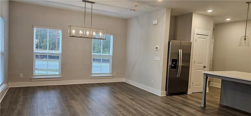 1727 Prospect Way Conyers, GA 30094 - Photo 11 of 38 a view of an empty room with wooden floor and a window