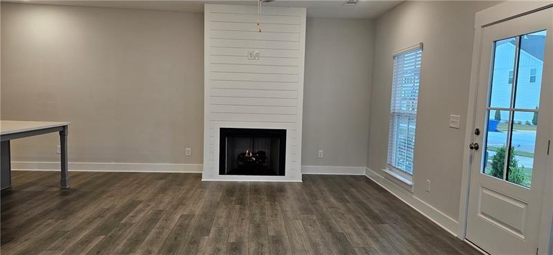 1727 Prospect Way Conyers, GA 30094 - Photo 13 of 38 a view of an empty room with wooden floor and a window