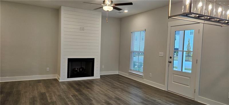 1727 Prospect Way Conyers, GA 30094 - Photo 14 of 38 an empty room with windows and a fireplace