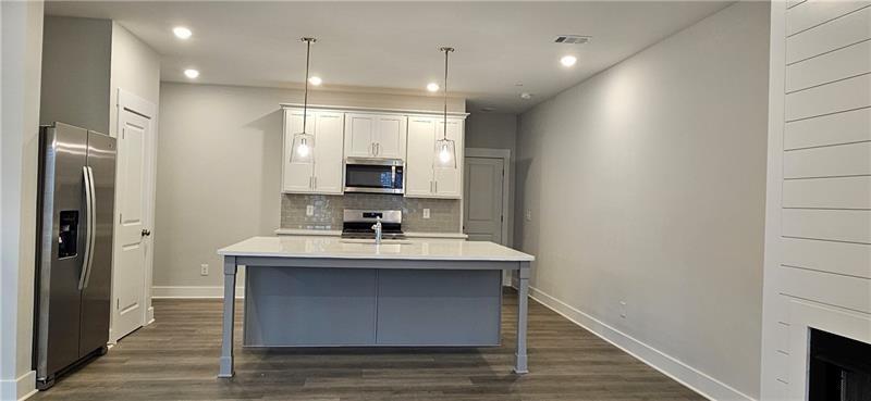 1727 Prospect Way Conyers, GA 30094 - Photo 16 of 38 a kitchen with kitchen island white cabinets and sink