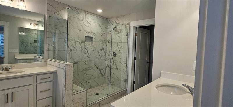 1727 Prospect Way Conyers, GA 30094 - Photo 36 of 38 a bathroom with a shower sink vanity and mirror