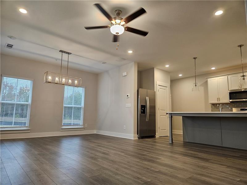 1727 Prospect Way Conyers, GA 30094 - Photo 8 of 38 a view of kitchen with refrigerator stove and wooden floor