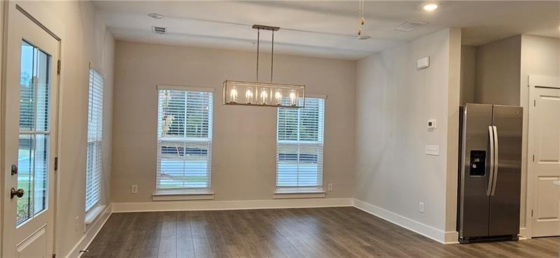 1727 Prospect Way Conyers, GA 30094 - Photo 9 of 38 a view of empty room with wooden floor and fan