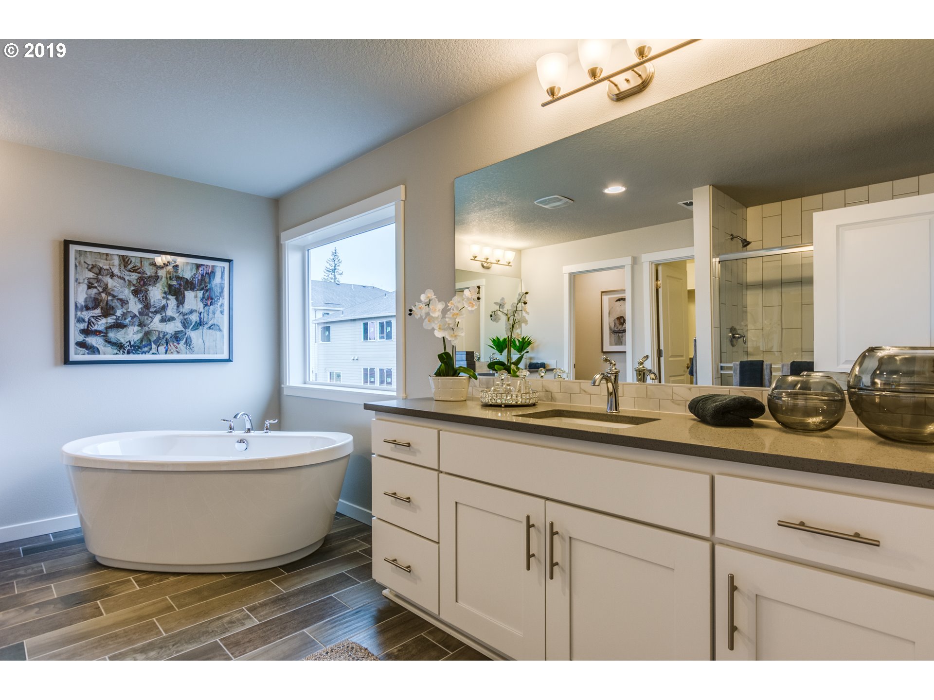 15975 Southwest Wren Lane Beaverton, OR 97007 - Photo 19 of 23 a spacious bathroom with a double vanity sink a mirror and a bathtub