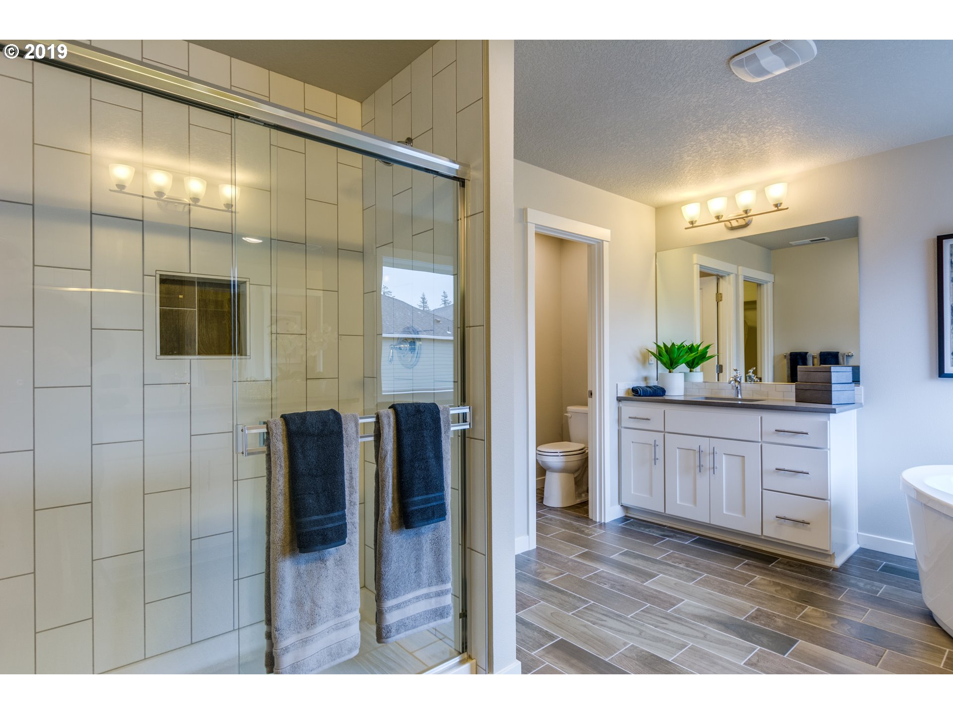 15975 Southwest Wren Lane Beaverton, OR 97007 - Photo 20 of 23 a bathroom with a granite countertop sink mirror and shower