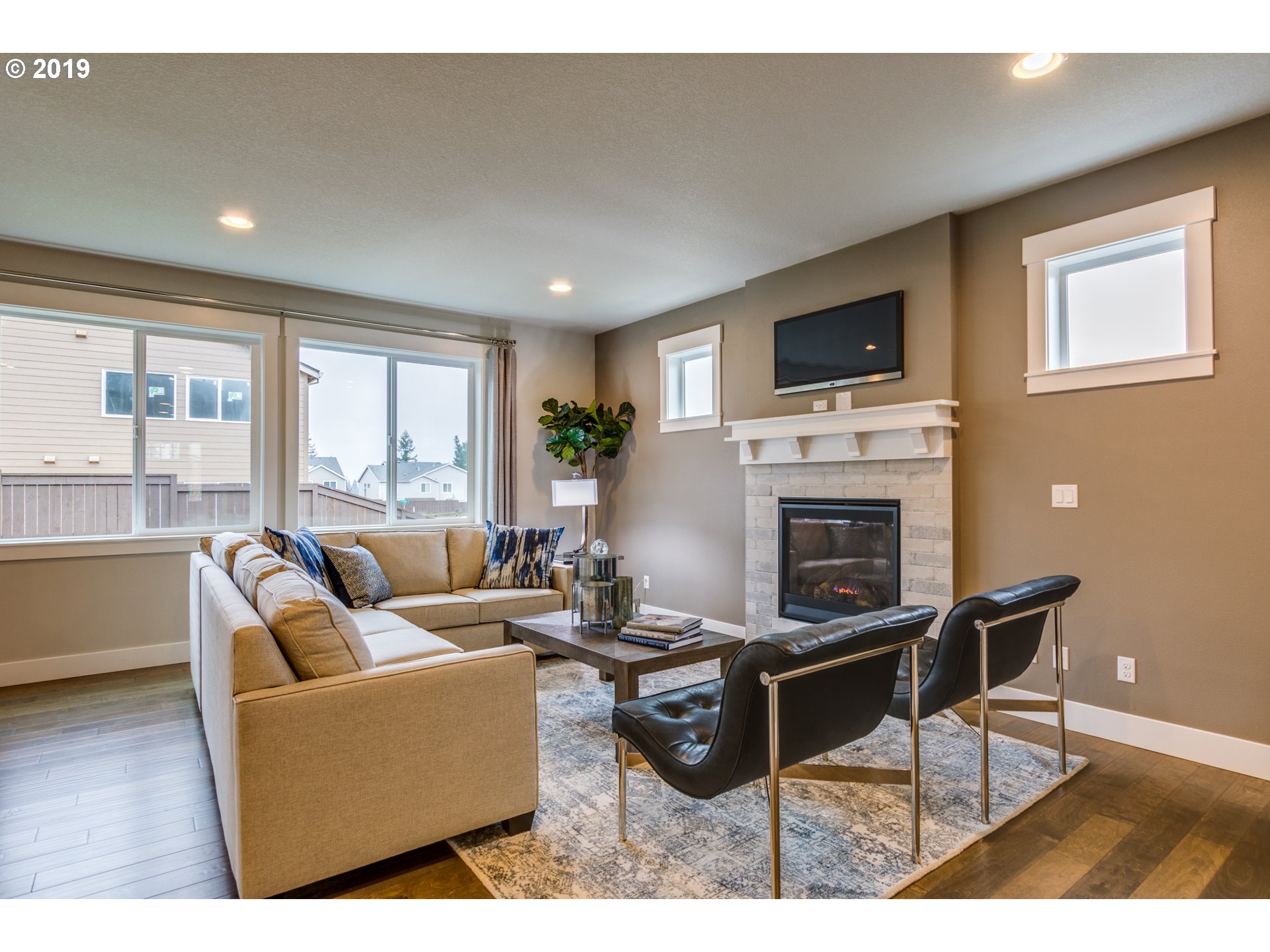 15975 Southwest Wren Lane Beaverton, OR 97007 - Photo 6 of 23 a living room with furniture a fireplace and a flat screen tv