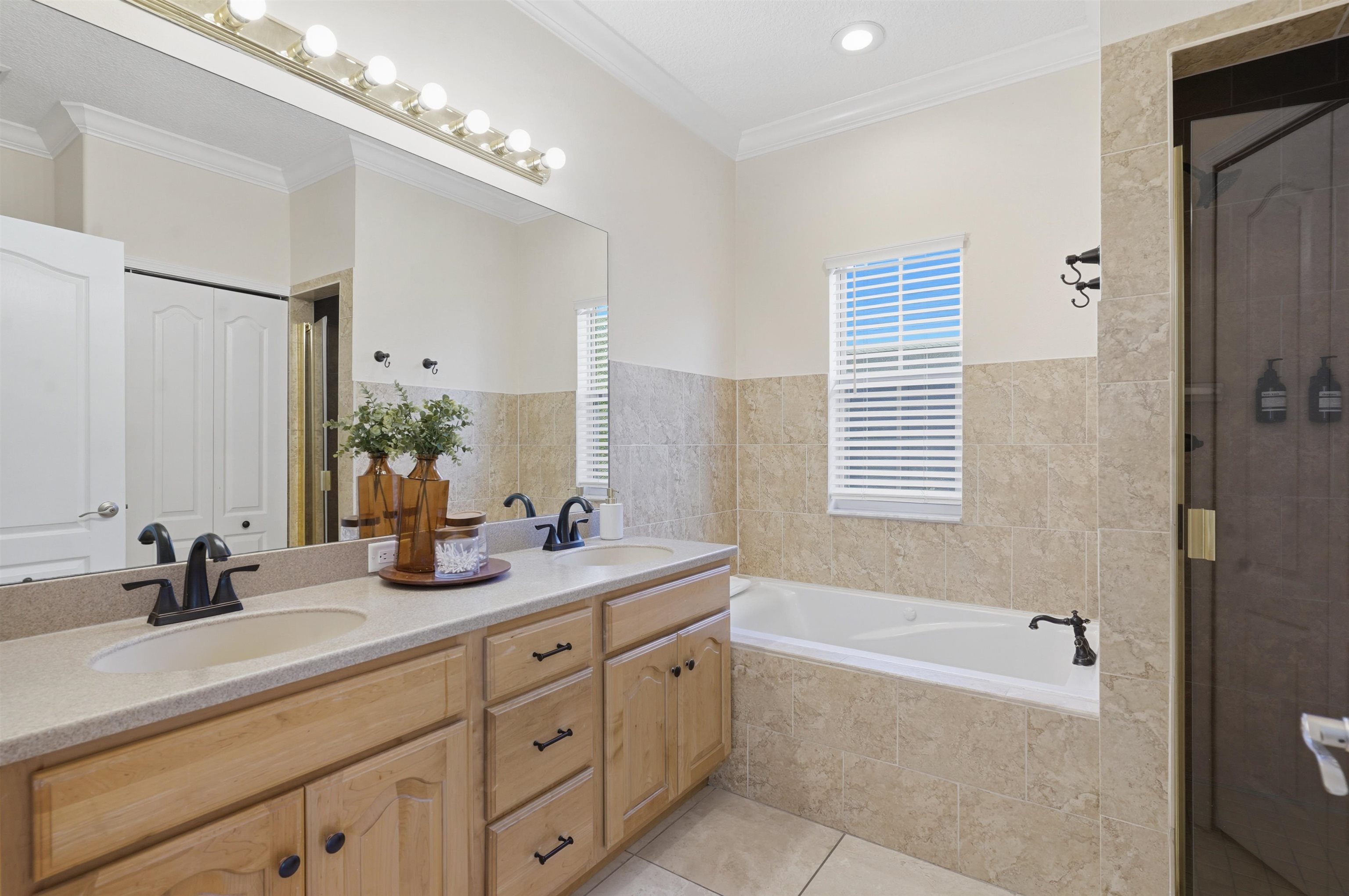 2 Lisbon Street St. Augustine, FL 32080 - Photo 25 of 39 a spacious bathroom with double vanity a mirror a double vanity and a bathtub