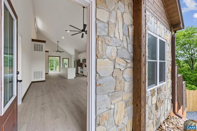 a view of a living room with hardwood floor and windows