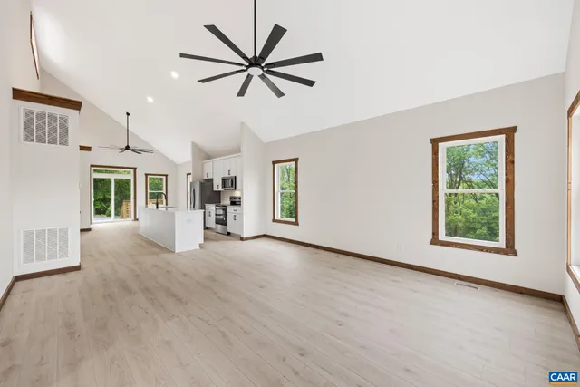 a bedroom with a large bed and a potted plant
