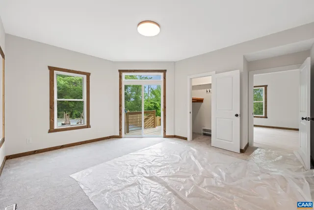 a living room with furniture a flat screen tv and a table