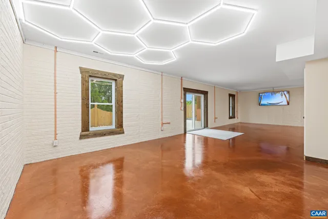 a view of backyard with potted plants and wooden fence