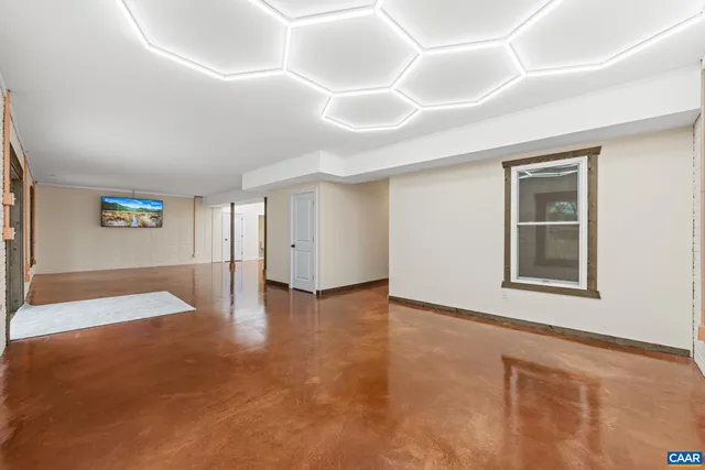 an aerial view of residential houses with outdoor space and trees