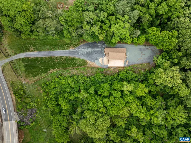 an empty room with windows lake and mountain view