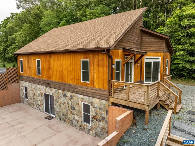 an aerial view of a house with a yard and lake view