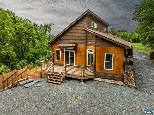 a view of backyard with deck and trees