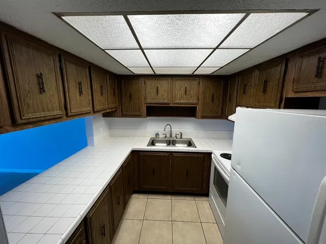 a kitchen with a sink and wooden cabinets