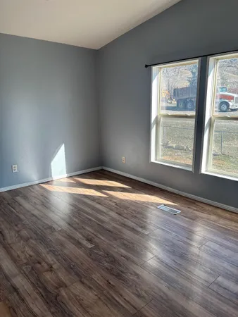 a view of room window and wooden floor