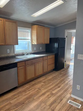 a kitchen with stainless steel appliances granite countertop a refrigerator sink and cabinets
