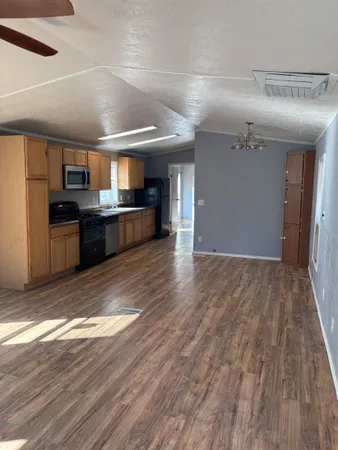 a view of a kitchen with a sink and wooden floor