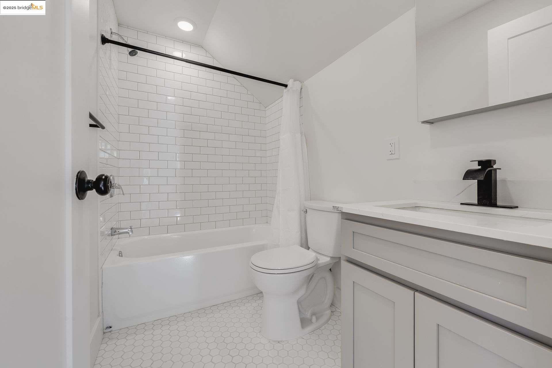 1238 12th Street Oakland, CA 94607 - Photo 24 of 55 a bathroom with a shower a toilet and a sink