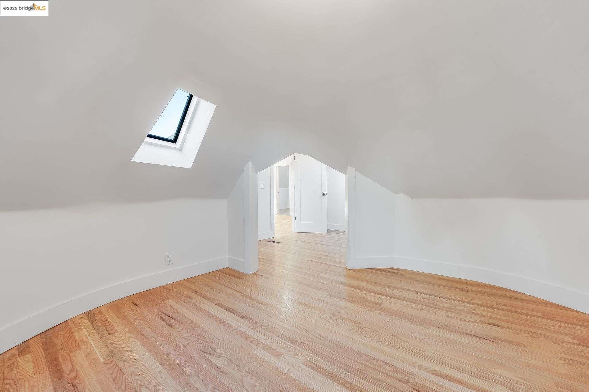 1238 12th Street Oakland, CA 94607 - Photo 31 of 55 a view of empty room with wooden floor and window