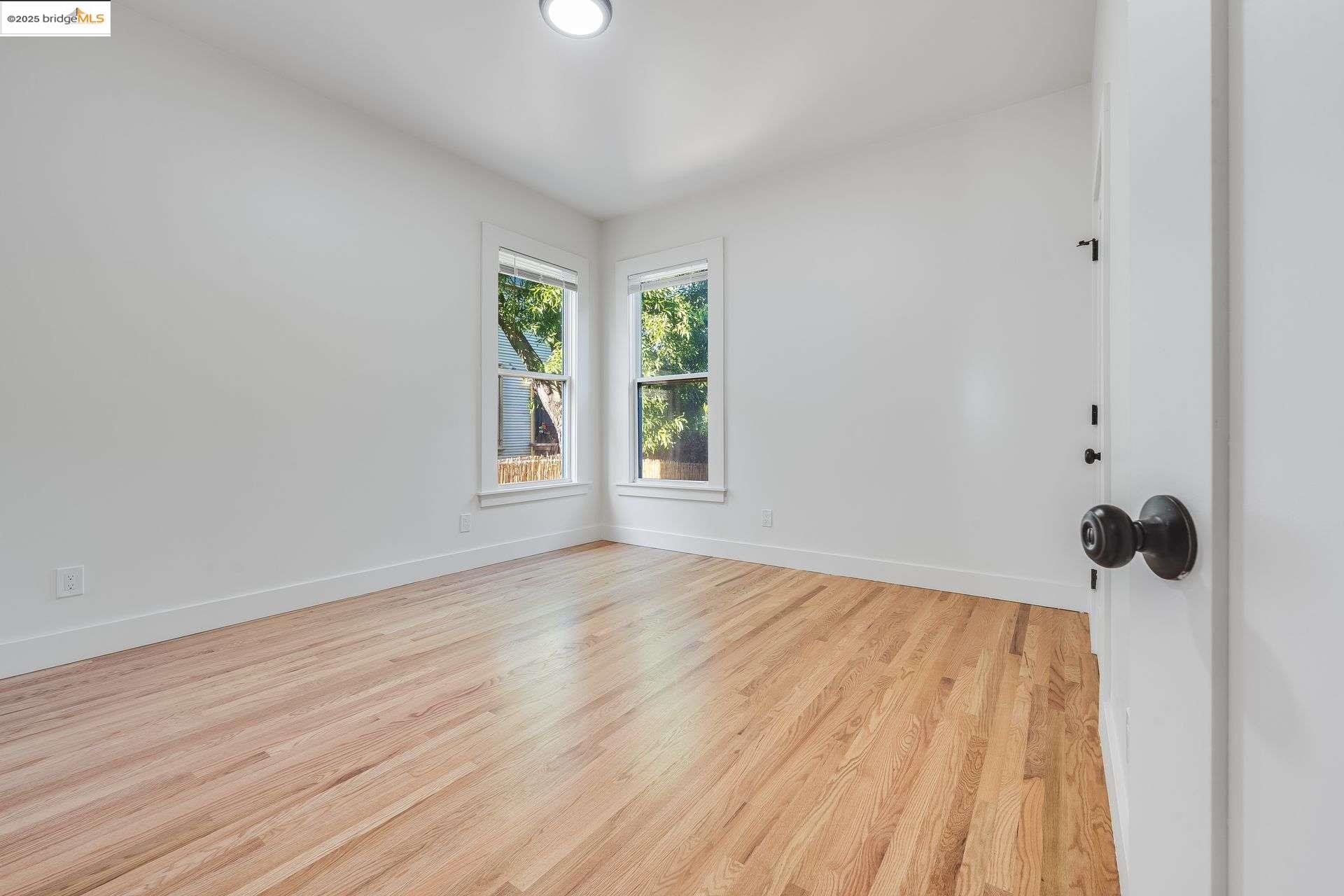 1238 12th Street Oakland, CA 94607 - Photo 34 of 55 a view of a room with wooden floor and a window