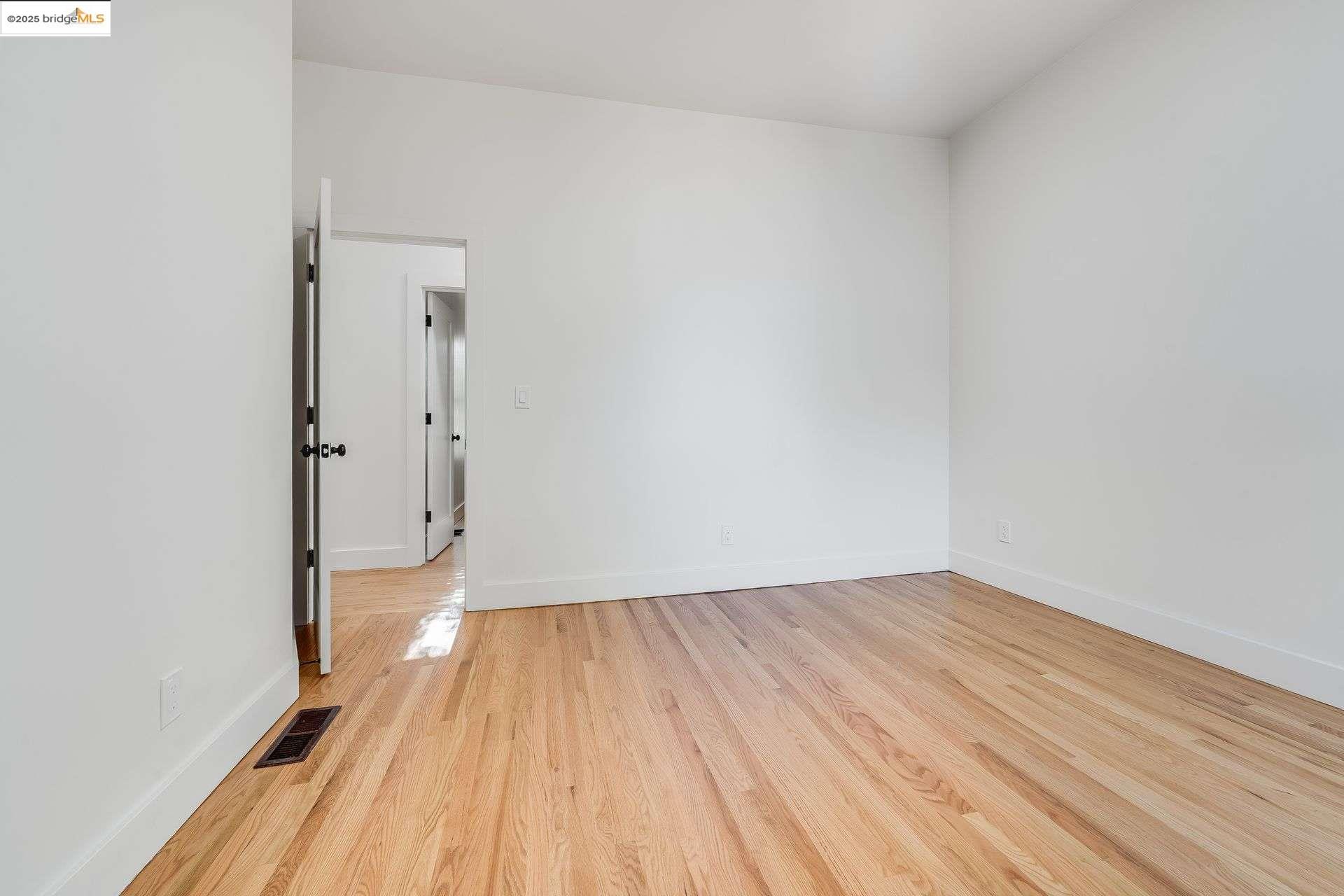 1238 12th Street Oakland, CA 94607 - Photo 35 of 55 a view of a room with wooden floor and white walls