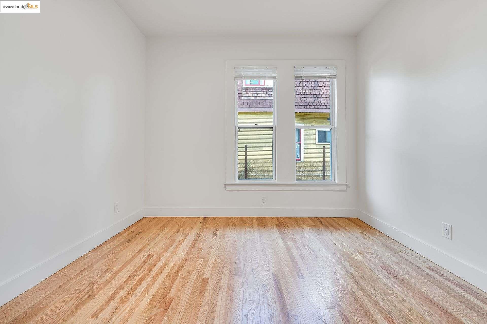 1238 12th Street Oakland, CA 94607 - Photo 38 of 55 a view of empty room with wooden floor and fan