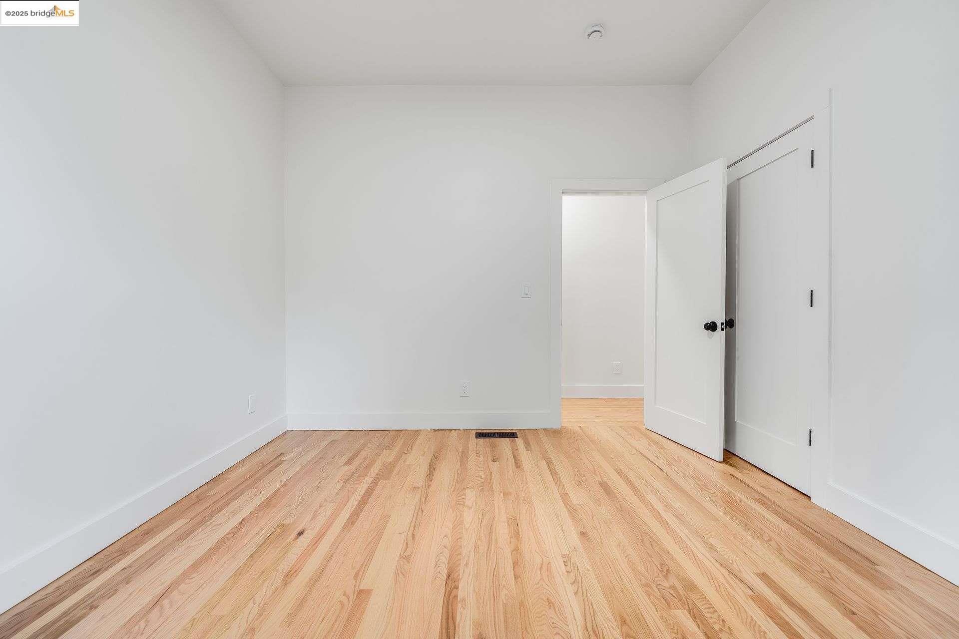 1238 12th Street Oakland, CA 94607 - Photo 39 of 55 a view of room with wooden floor and white walls