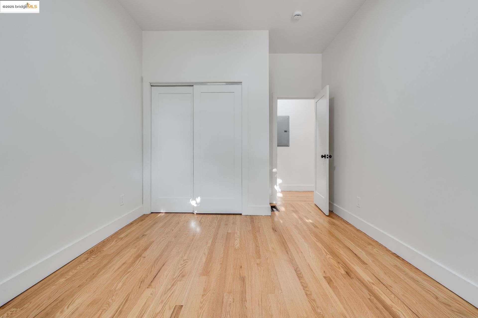 1238 12th Street Oakland, CA 94607 - Photo 41 of 55 a view of a room with wooden floor and white walls