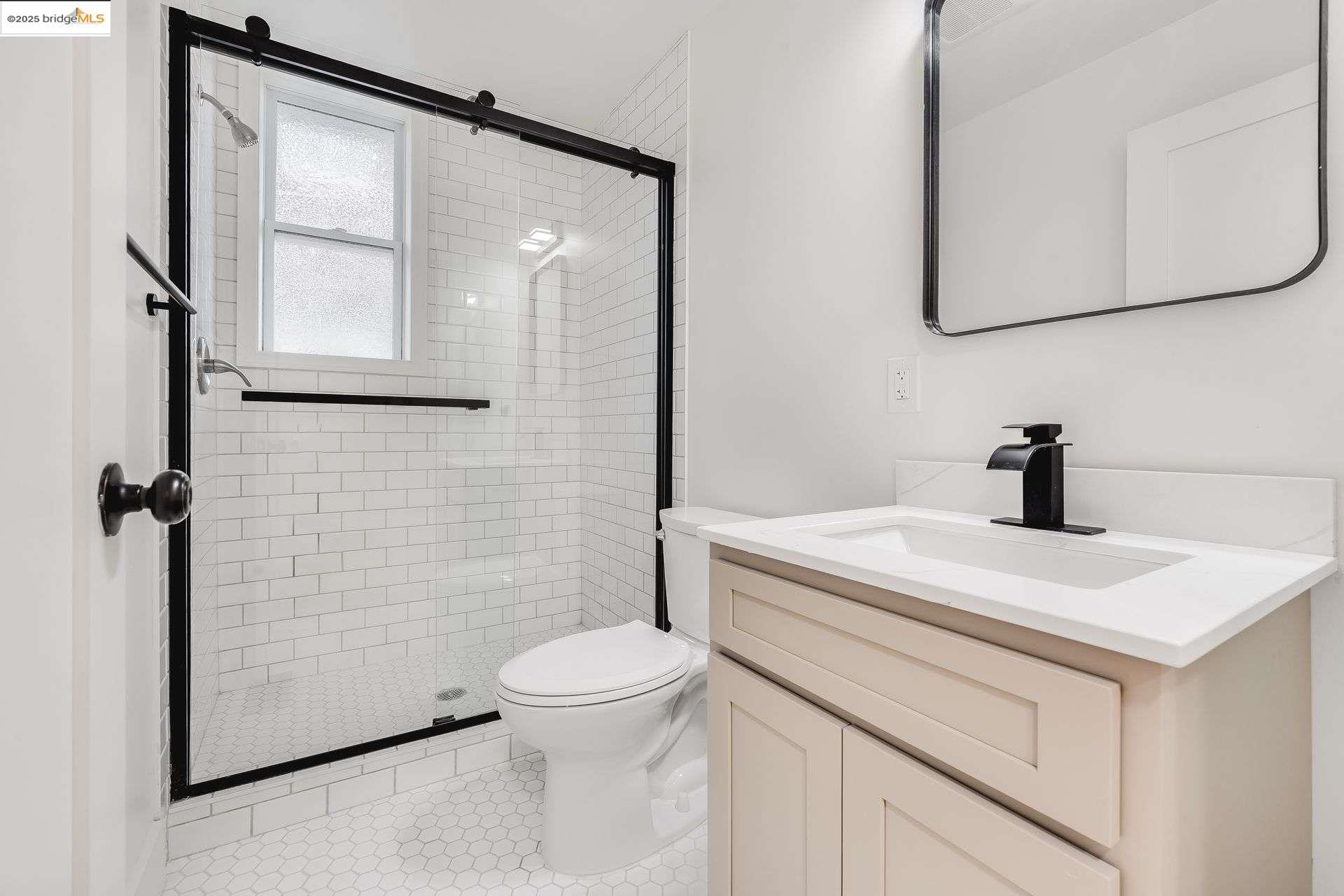 1238 12th Street Oakland, CA 94607 - Photo 44 of 55 a bathroom with a sink a toilet and mirror