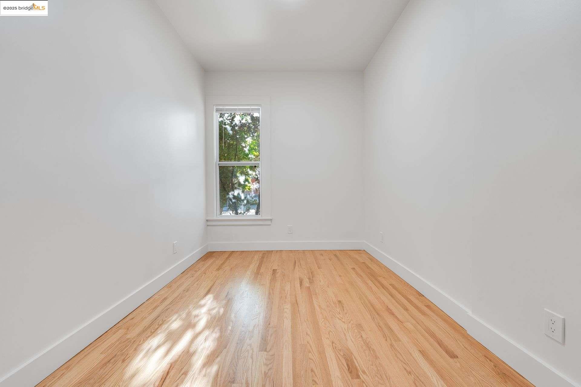 1238 12th Street Oakland, CA 94607 - Photo 50 of 55 a view of room with window and wooden floor