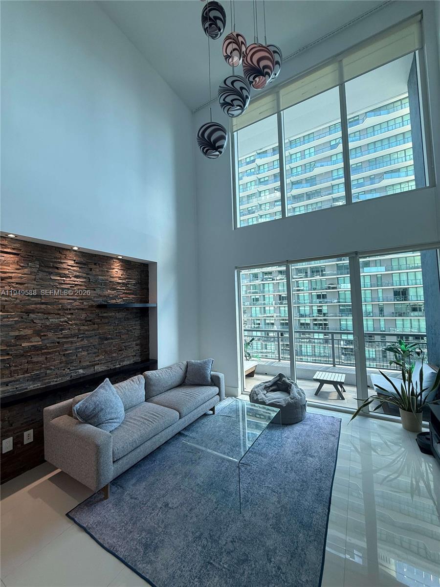 60 Southwest 13th Street, Unit 3808 Miami, FL 33130 - Photo 13 of 38 a living room with furniture large windows and flat screen tv