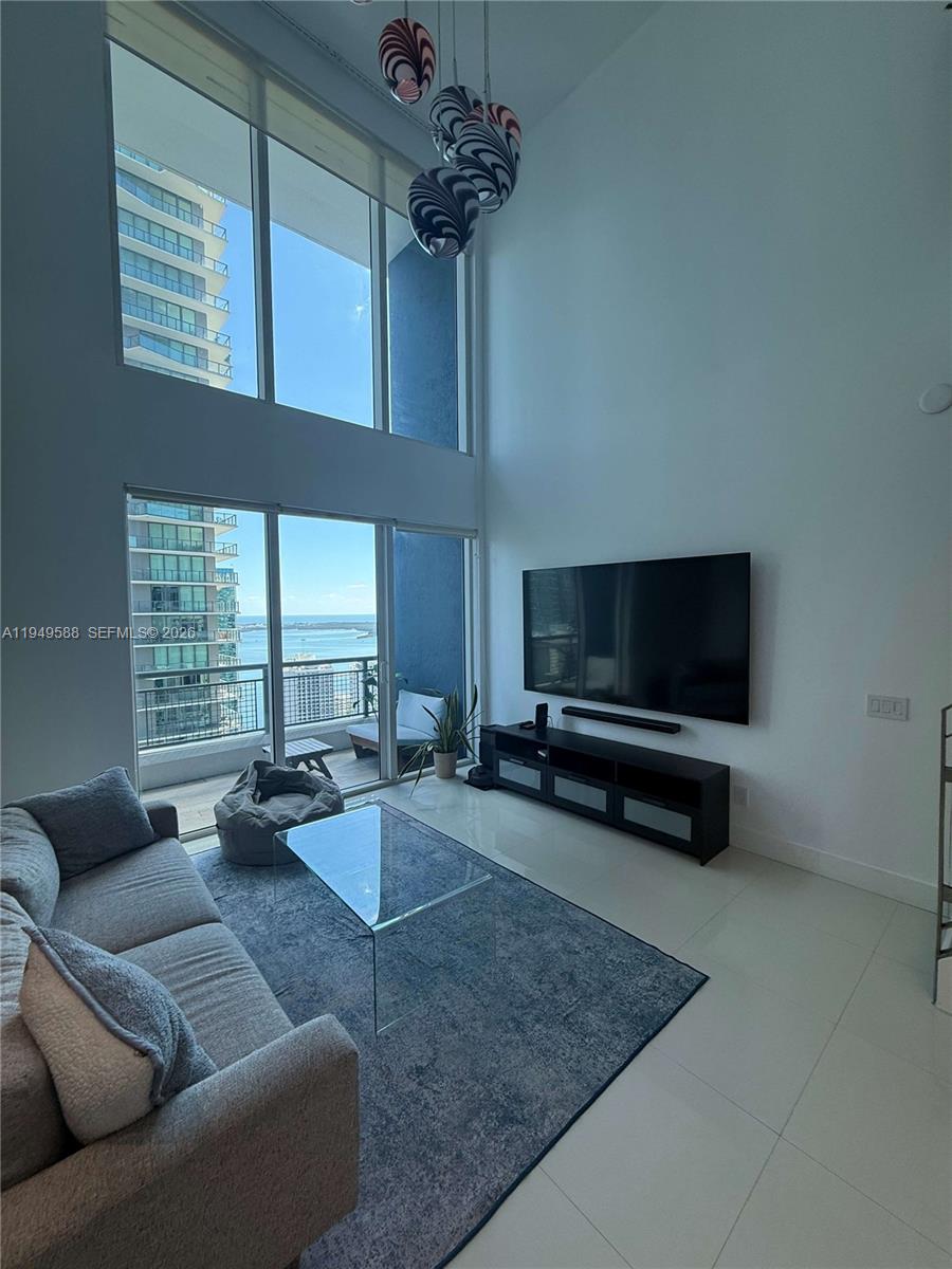 60 Southwest 13th Street, Unit 3808 Miami, FL 33130 - Photo 14 of 38 a living room with furniture and a flat screen tv